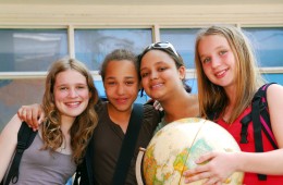 teen girls holding a globe