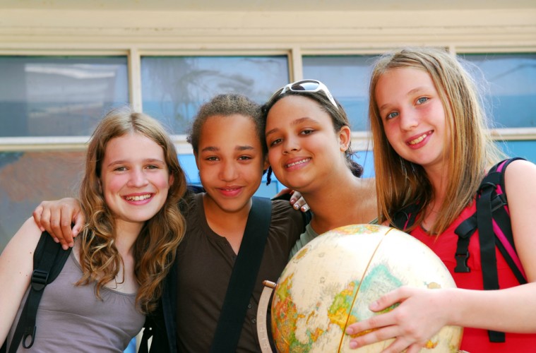 teen girls holding a globe