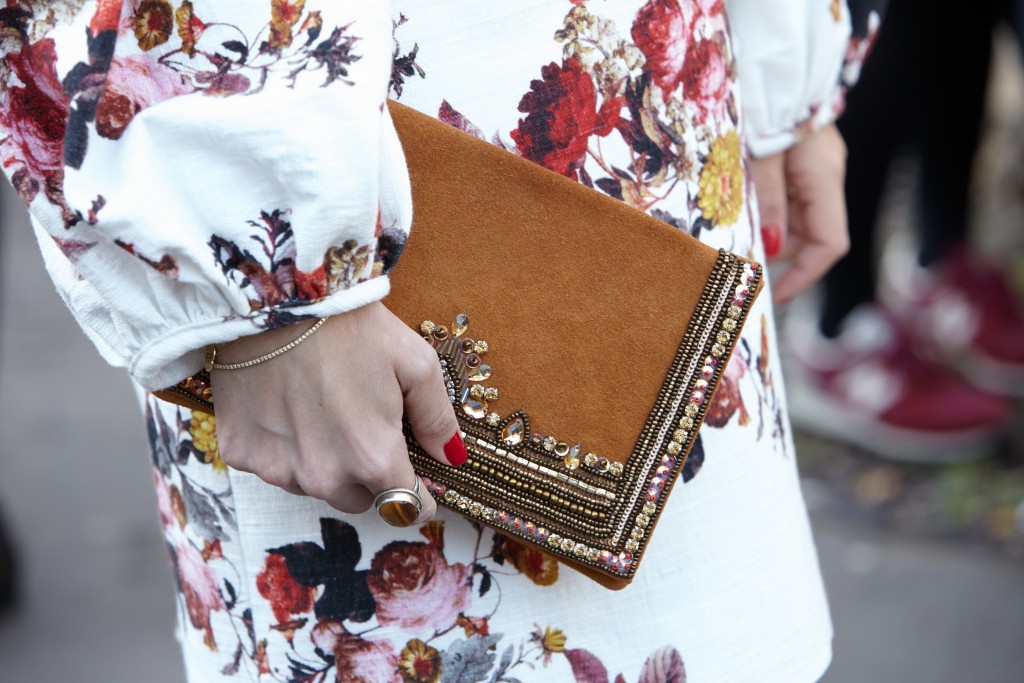 Red nails and tribal pattern bclutch from PFW
